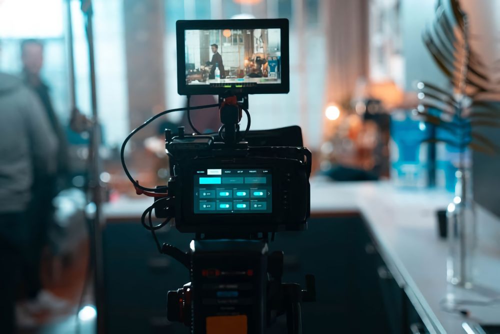Filming on the set of Grey Goose Live Like, looking through a camera lens.
