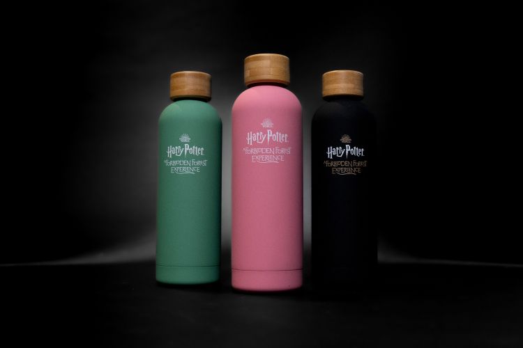 Different colored water bottles – green, pink, black.