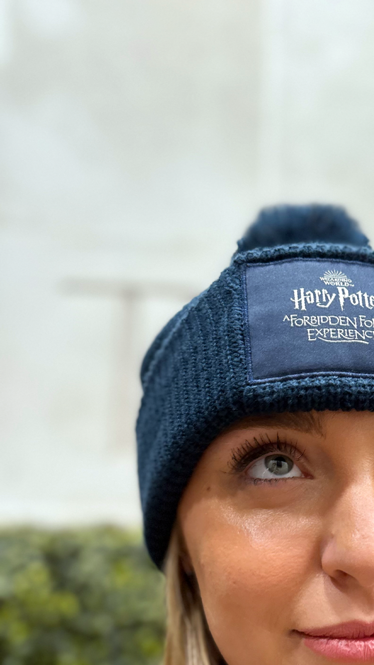 A woman modelling a blue Harry Potter Forbidden Forest hat.