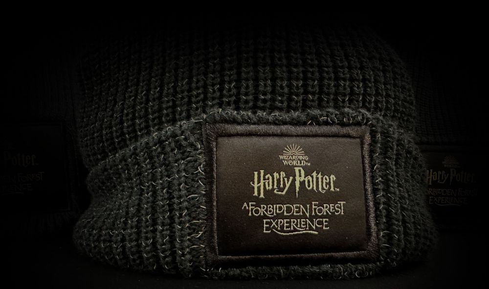 A brown wolly hat with the Forbidden Forest logo stitched on the front.