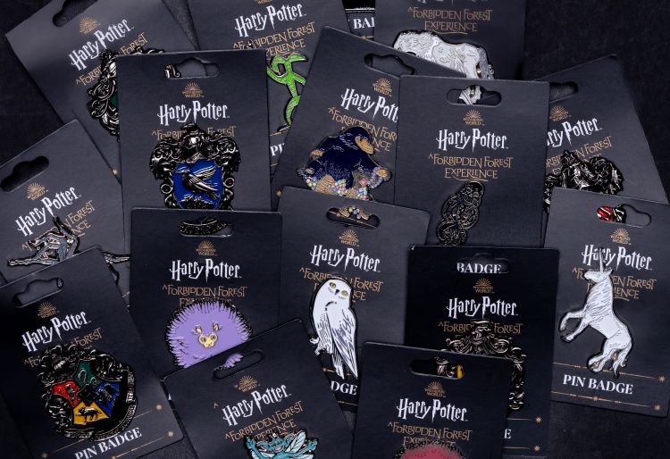 various Forbidden Forest pin badges.