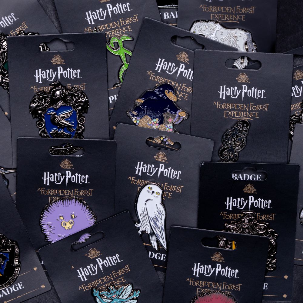 various Forbidden Forest pin badges.