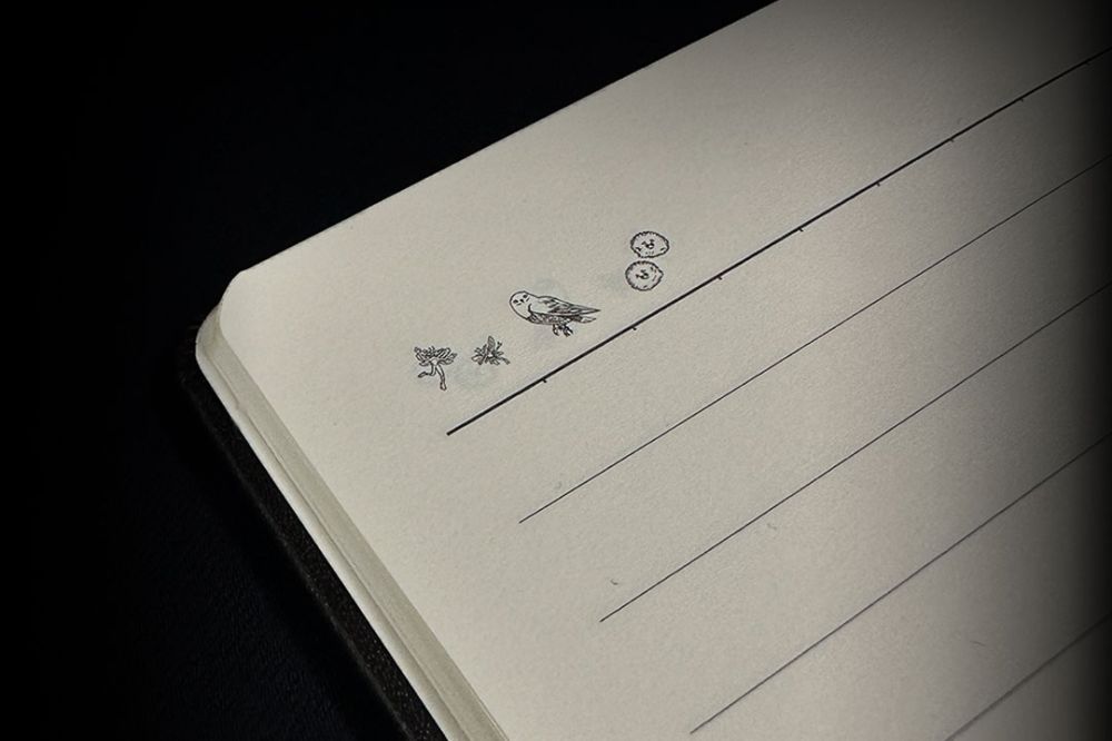 A notebook with Harry Potter symbols in the top corner of the page.