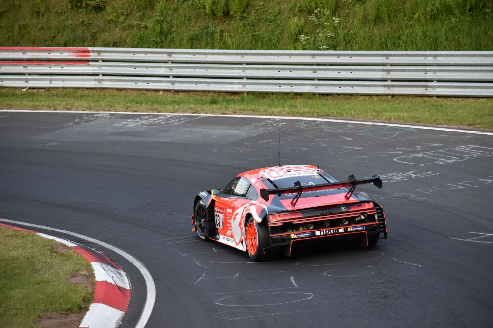 An Audi car racing around a track corner in Nürburg, Germany.