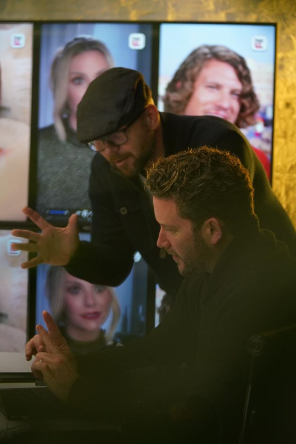 Nicky and Ben in front of screens in the Paradise office.
