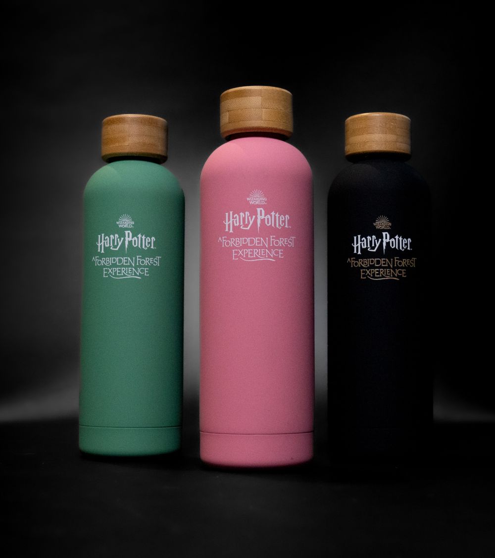 Different colored water bottles – green, pink, black.