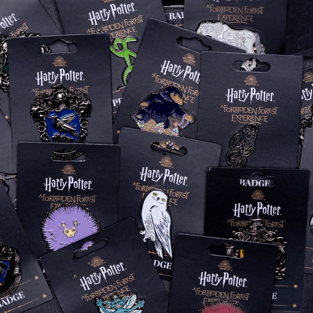 various Forbidden Forest pin badges.