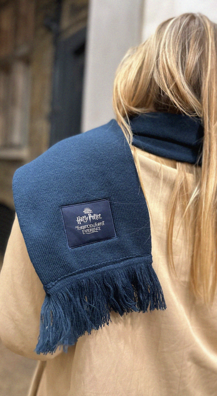 A blue scarf flung over a shoulder.