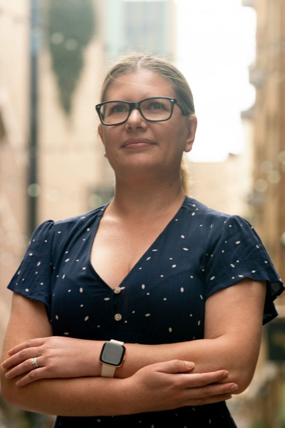 Hayley Edwards smiling and folding her arms outside the Paradise office.