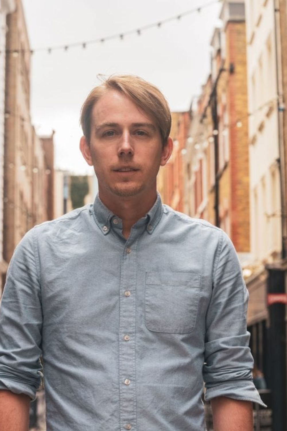 Johnny Garner wearing a blue shirt on the street in Covent Garden.