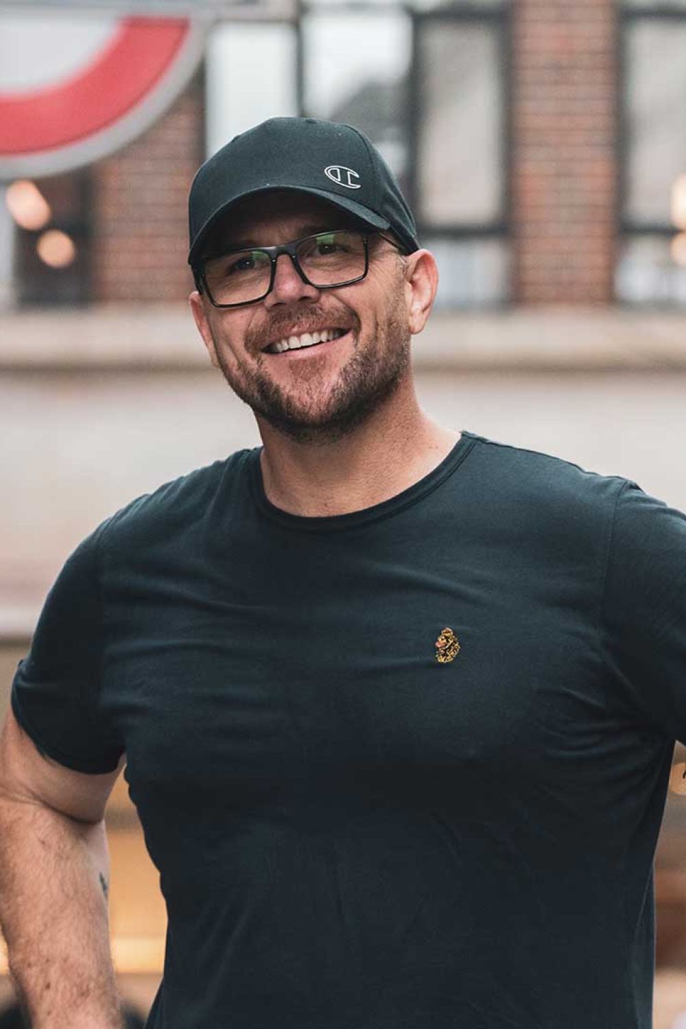 Nicky Cook smiling at the camera on the street.